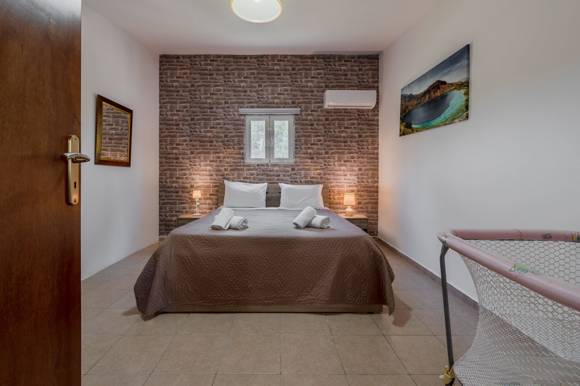 Guest bedroom with two single beds and garden view.
