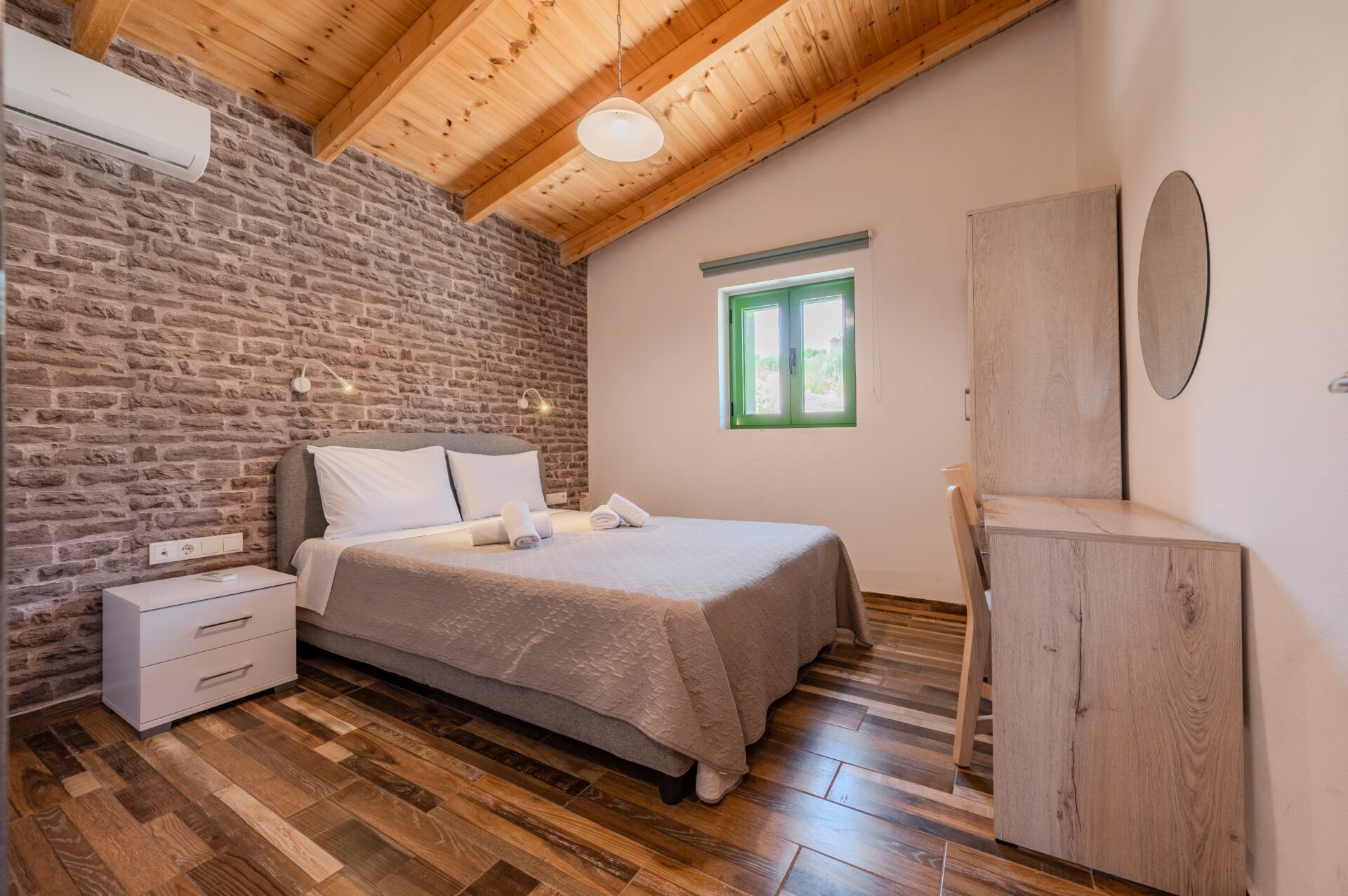 Spacious living room with fireplace, sofas, and large windows facing the garden.