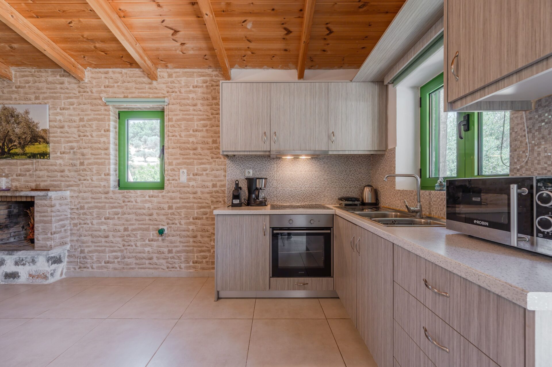 Fully equipped kitchen with oven, stove, refrigerator, and dining table.